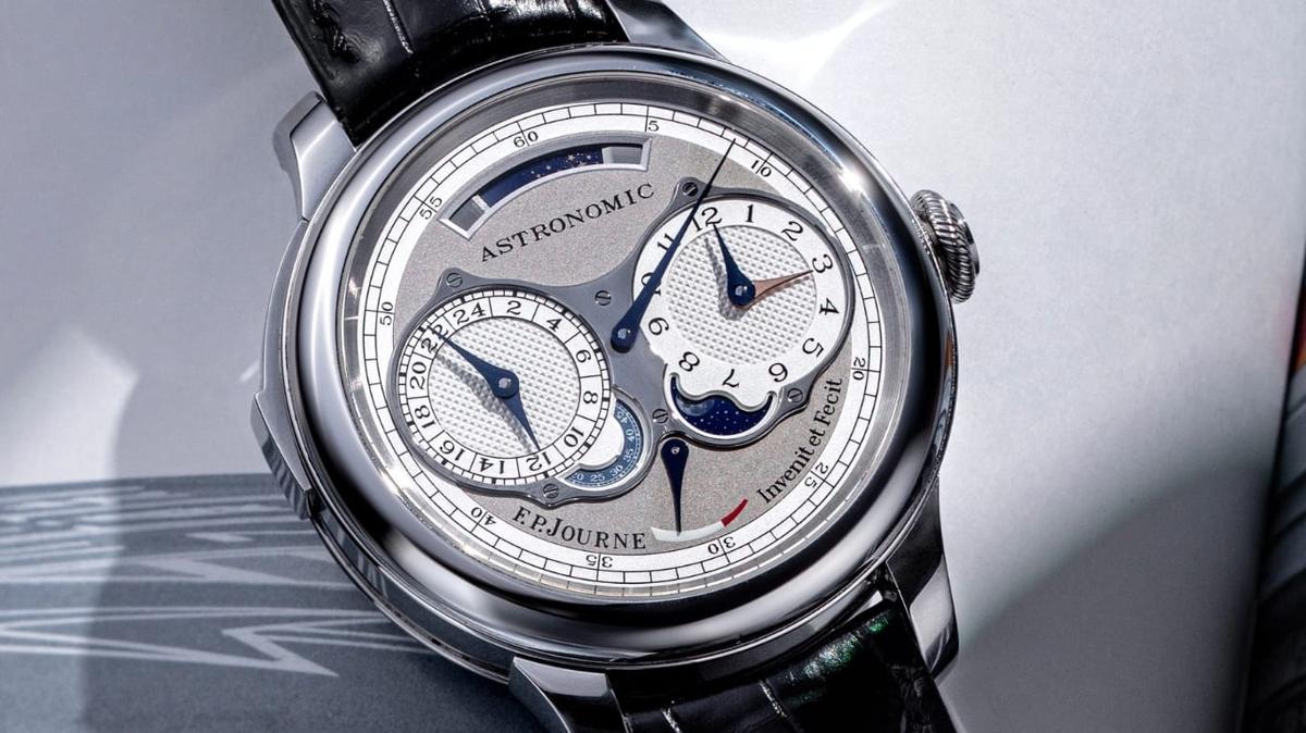 The F.P. Journe Astronomic Souveraine on a black alligator strap, its silver guilloche dial showing twin subdials, a moon phase and a power reserve, signed Invenit et Fecit.