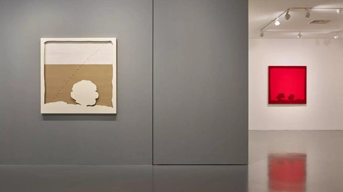 A gallery installation view of two minimalist works, evoking the spatial concerns of Lucio Fontana and Spazialismo.