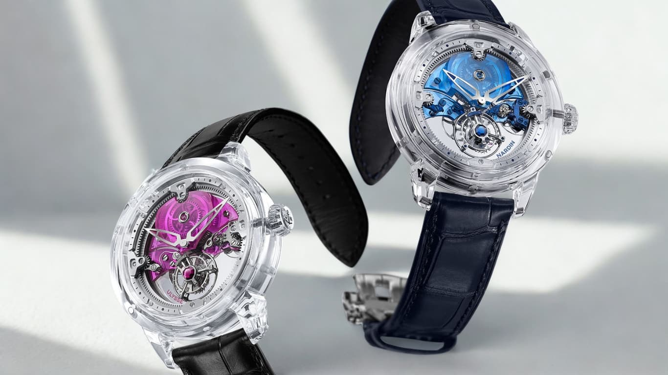 Two Ulysse Nardin sapphire-cased tourbillon watches with pink and blue movements visible through their transparent cases — the modern face of the manufacture whose marine-chronometer legacy underwrites every reference it ships today.