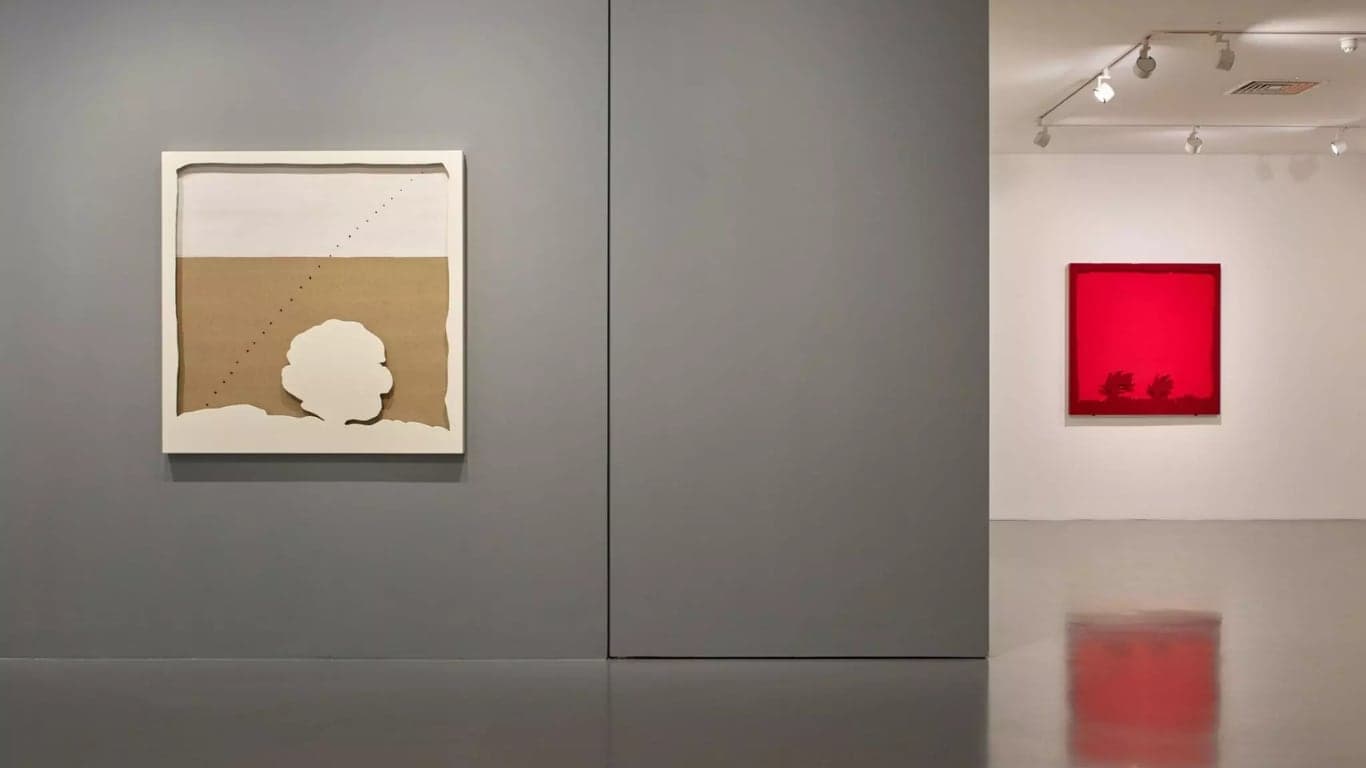A gallery installation view of two minimalist works, evoking the spatial concerns of Lucio Fontana and Spazialismo.