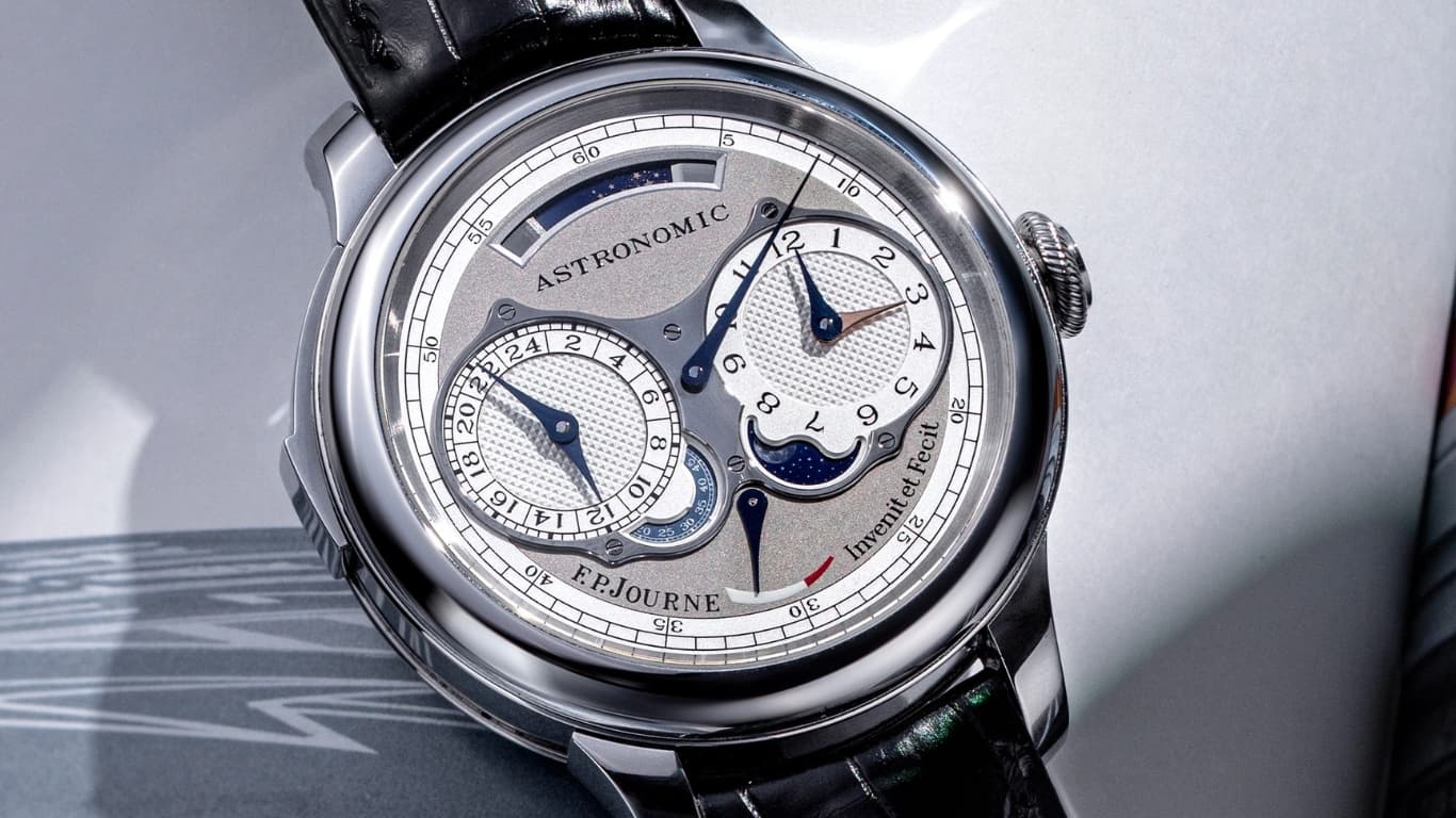 The F.P. Journe Astronomic Souveraine on a black alligator strap, its silver guilloche dial showing twin subdials, a moon phase and a power reserve, signed Invenit et Fecit.