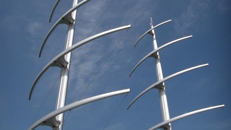The DynaRig system on the Maltese Falcon at close range — three free-standing rotating carbon-fibre masts carrying square sails on fixed yards, the entire sail plan deployable from the bridge by a single operator.