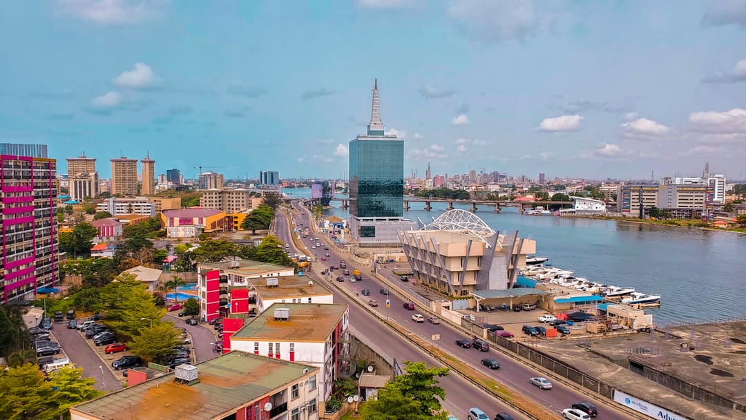 Aerial view of Victoria Island in Lagos, Nigeria, with the Civic Towers, a waterfront marina and traffic moving along Five Cowries Creek.