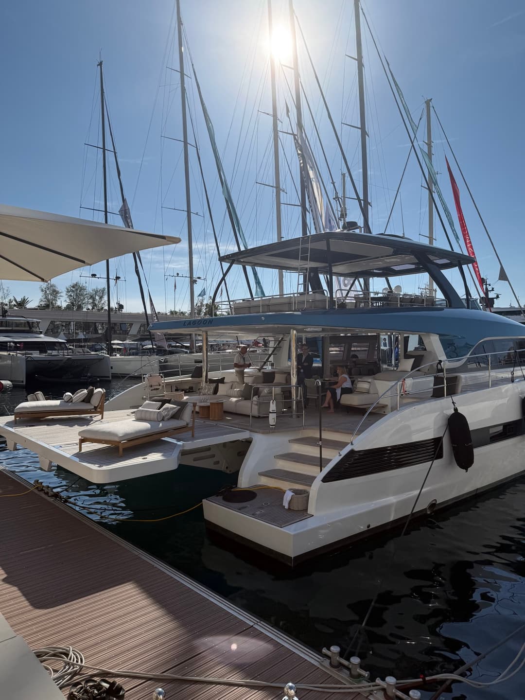 A Lagoon catamaran displayed in bright sunlight at the Monaco Yacht Show marina