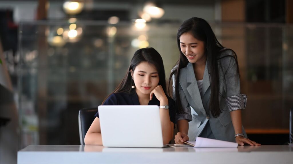 Two girls providing their details to open an IRA account